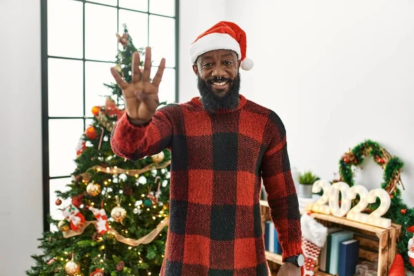 Африканский Американец Шляпе Санта Клауса Стоит Рождественской Елки Показывает Пальцами — стоковое фото