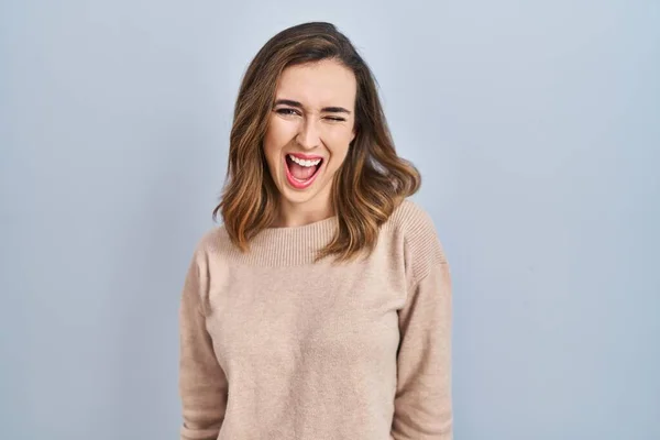 Young Woman Standing Isolated Background Winking Looking Camera Sexy Expression — Stock Fotó