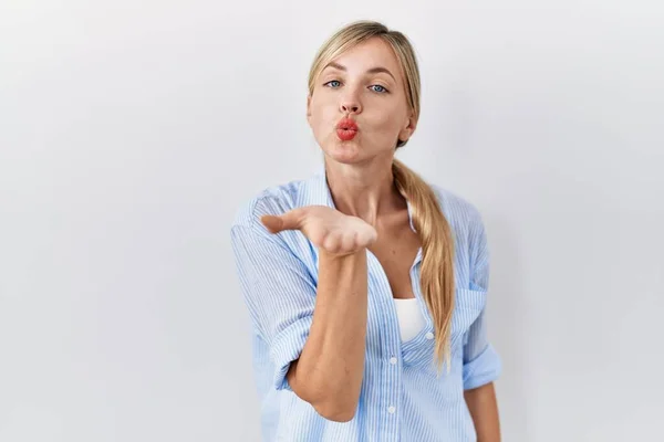 Hermosa Mujer Rubia Pie Sobre Fondo Blanco Mirando Cámara Soplando —  Fotos de Stock