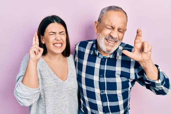 Hispanic Father Daughter Wearing Casual Clothes Gesturing Finger Crossed Smiling — Stockfoto