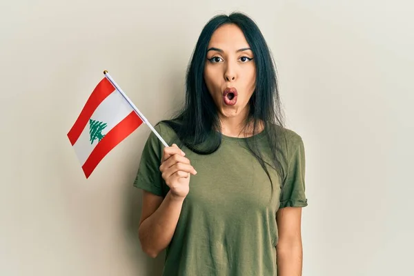 Young Hispanic Girl Holding Lebanon Flag Scared Amazed Open Mouth — Fotografia de Stock
