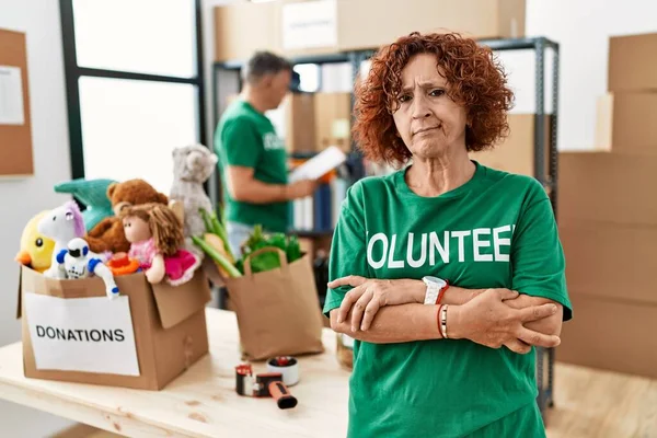 Middle Age Woman Wearing Volunteer Shirt Donations Stand Skeptic Nervous — Stok fotoğraf