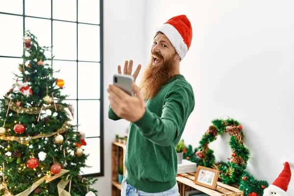 Young Redhead Man Having Video Call Standing Christmas Tree Home — Stockfoto