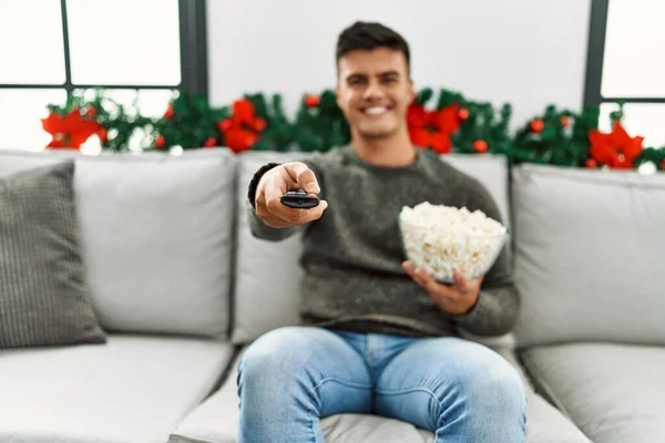 Young Hispanic Man Watching Sitting Sofa Christmas Decor Home — Stockfoto