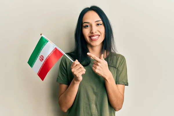 Young Hispanic Girl Holding Iran Flag Smiling Happy Pointing Hand — Stock Fotó