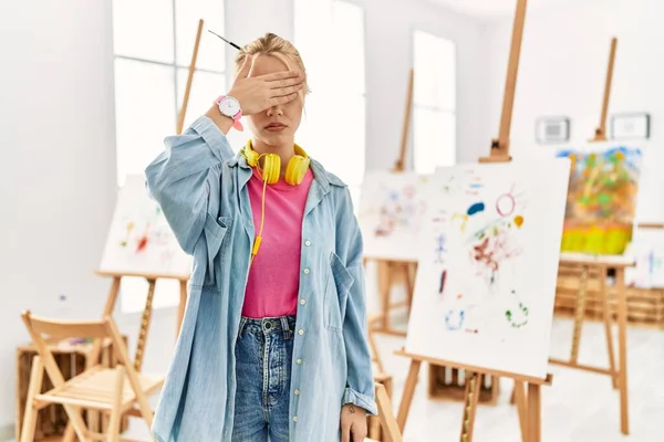 Young Caucasian Girl Art Studio Covering Eyes Hand Looking Serious — Foto de Stock