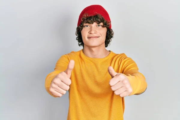 Handsome Young Man Wearing Wool Hat Approving Doing Positive Gesture — стоковое фото