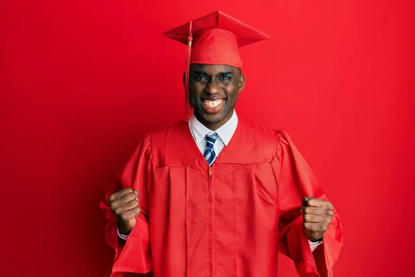 Young African American Man Wearing Graduation Cap Ceremony Robe Celebrating — стоковое фото
