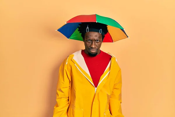 Young African American Man Wearing Yellow Raincoat Skeptic Nervous Frowning — Stockfoto