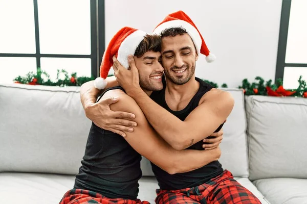 Two Hispanic Men Couple Hugging Each Other Sitting Christmas Decor — Stock Photo, Image