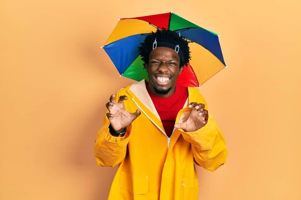 Young African American Man Wearing Yellow Raincoat Smiling Funny Doing — Fotografia de Stock