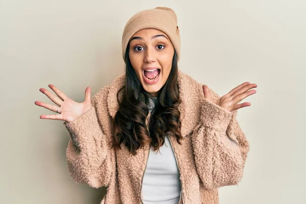 Young Hispanic Woman Wearing Wool Sweater Winter Hat Celebrating Crazy —  Fotos de Stock
