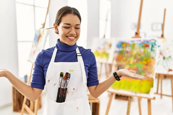 Young Brunette Woman Art Studio Smiling Showing Both Hands Open — стоковое фото