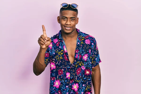 Young Black Man Wearing Hawaiian Shirt Sunglasses Showing Pointing Finger — Stock Fotó