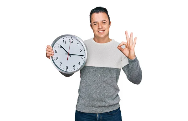 Handsome Young Man Holding Big Clock Doing Sign Fingers Smiling — Stock Photo, Image