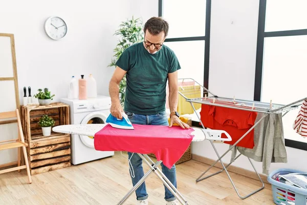 Middle Age Hispanic Man Ironing Clothes Home — Stock Photo, Image