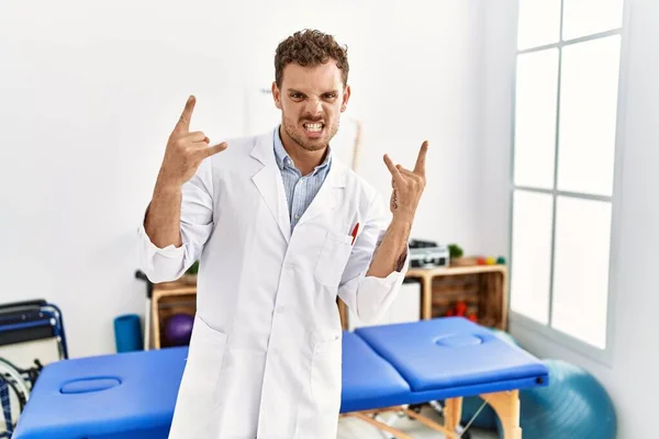 Handsome Young Man Working Pain Recovery Clinic Shouting Crazy Expression — Stockfoto