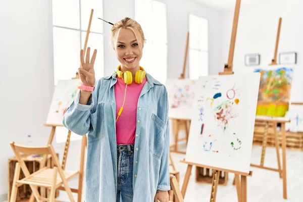Young Caucasian Girl Art Studio Showing Pointing Fingers Number Three — Stockfoto