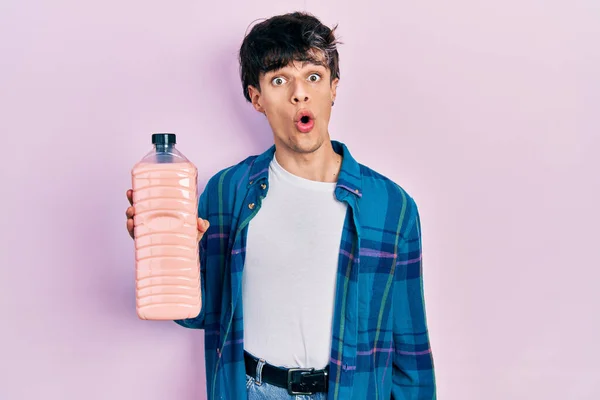 Handsome Hipster Young Man Holding Detergent Bottle Scared Amazed Open — Stock Photo, Image