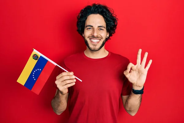 Handsome Hispanic Man Holding Venezuelan Flag Doing Sign Fingers Smiling — Foto Stock