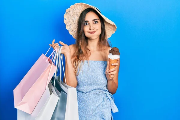 Young Hispanic Girl Holding Shopping Bags Ice Cream Puffing Cheeks — Stock fotografie