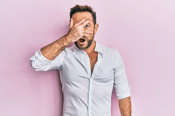 Homem Meia Idade Vestindo Roupas Casuais Espreitando Choque Cobrindo Rosto — Fotografia de Stock