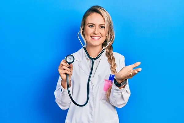 Beautiful Young Blonde Doctor Woman Holding Stethoscope Smiling Friendly Offering — Photo