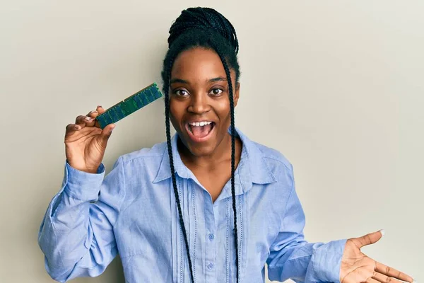 African American Woman Braided Hair Holding Ram Memory Celebrating Achievement — Stock Fotó