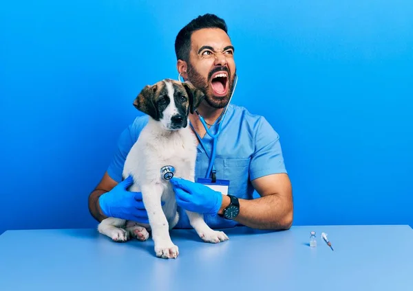 Handsome Hispanic Veterinary Man Beard Checking Dog Health Using Stethoscope — стоковое фото