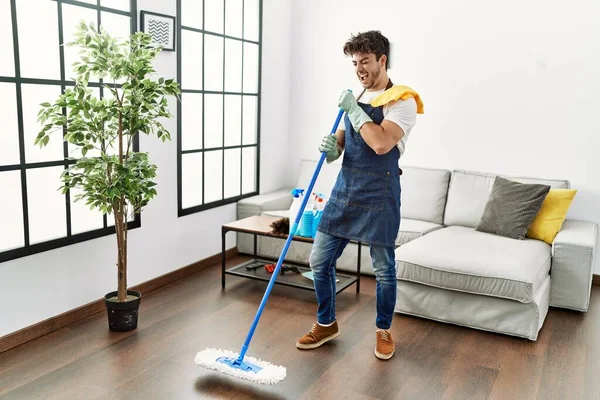 Young Hispanic Man Doing Chores Singing Using Mop Microphone Home — Stock Photo, Image