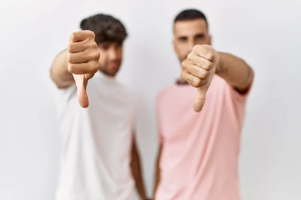 Young Gay Couple Standing Isolated Background Looking Unhappy Angry Showing — Stock Photo, Image