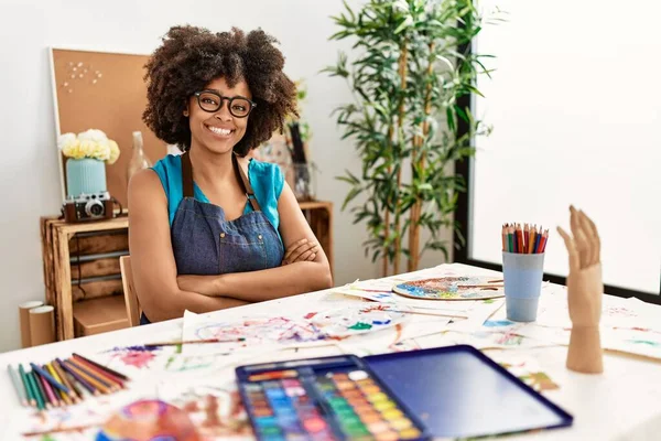 美丽动人的非洲裔美国女人 在艺术工作室里画着非洲裔的头发 高兴的脸上挂着交叉的胳膊微笑着看着相机 积极的人 — 图库照片