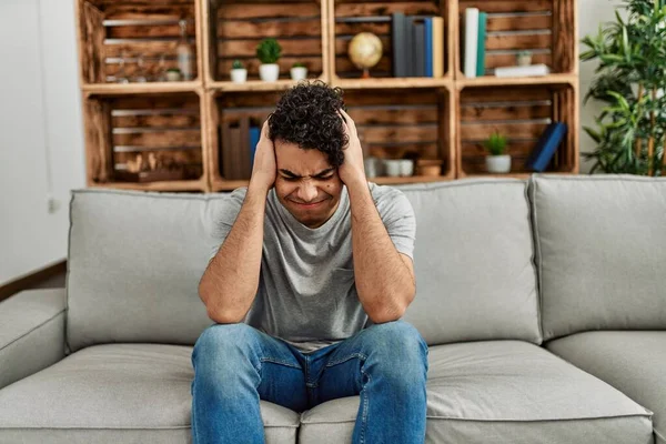 Young Hispanic Man Wearing Casual Clothes Sitting Sofa Home Suffering — Stock Photo, Image