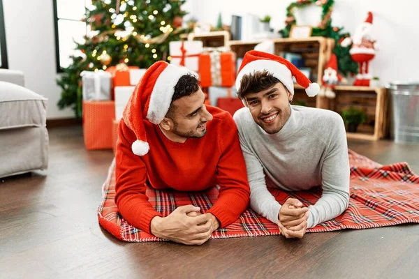 Two Hispanic Men Couple Smiling Confident Lying Christmas Tree Home — ストック写真