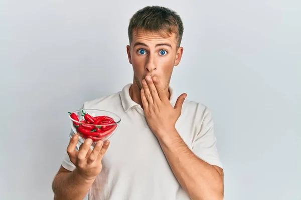 Young Caucasian Man Holding Bowl Red Pepper Covering Mouth Hand — Stock Photo, Image