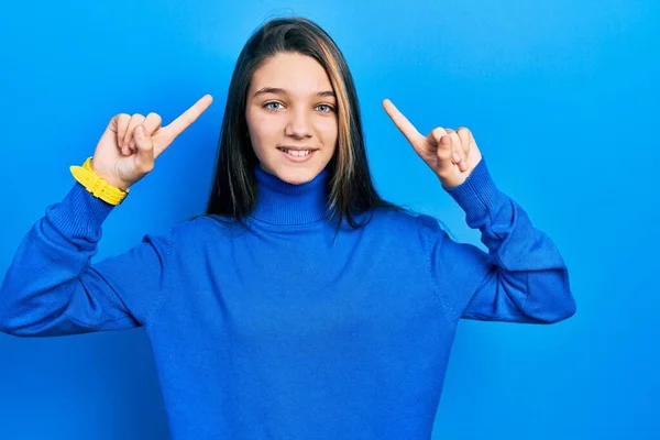 Young Brunette Girl Wearing Turtleneck Sweater Smiling Amazed Surprised Pointing — Stock Photo, Image