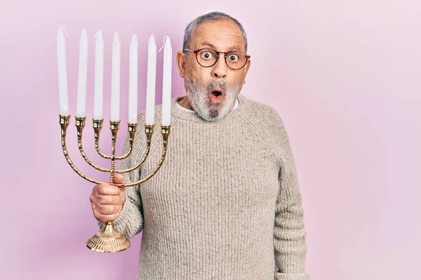 Handsome Senior Man Beard Holding Menorah Hanukkah Jewish Candle Scared — Stock Photo, Image
