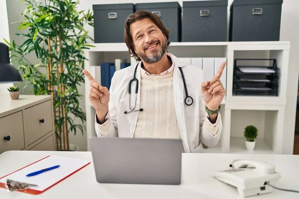 Bonito Médico Meia Idade Que Trabalha Clínica Sorrindo Confiante Apontando — Fotografia de Stock