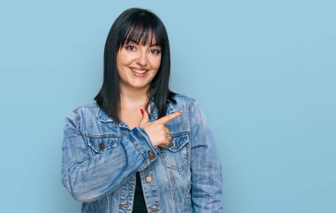 Yüzünde mutlu ve doğal bir ifade olan, elleri ve parmaklarıyla işaret eden, güler yüzlü, gündelik kıyafetler giyen genç İspanyol kadın. 