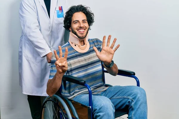 Handsome Hispanic Man Sitting Wheelchair Wearing Neck Collar Showing Pointing — Stock Photo, Image