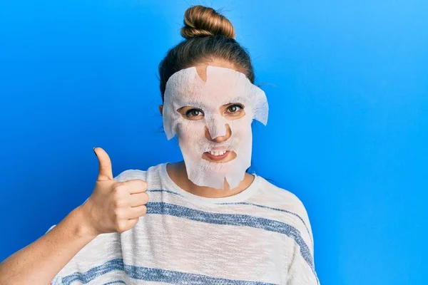 Jovem Loira Usando Máscara Facial Beleza Sorrindo Feliz Positivo Polegar — Fotografia de Stock
