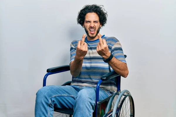 Handsome Hispanic Man Sitting Wheelchair Showing Middle Finger Doing Fuck — Stockfoto