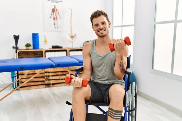 Giovane Uomo Ispanico Che Riabilitazione Utilizzando Manubri Seduti Sulla Sedia — Foto Stock