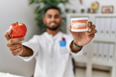 Diyetisyen üniformalı genç bir Arap klinikte sağlıklı beslenme talep ediyor.