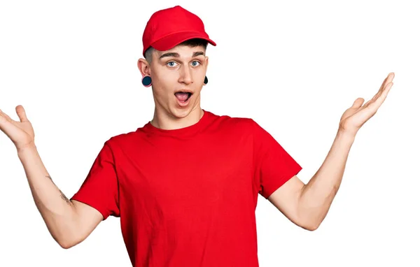 Young Caucasian Boy Ears Dilation Wearing Delivery Uniform Cap Celebrating — Stock Photo, Image