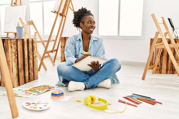 stock image Young african american artist woman smiling happy drawing at art studio.