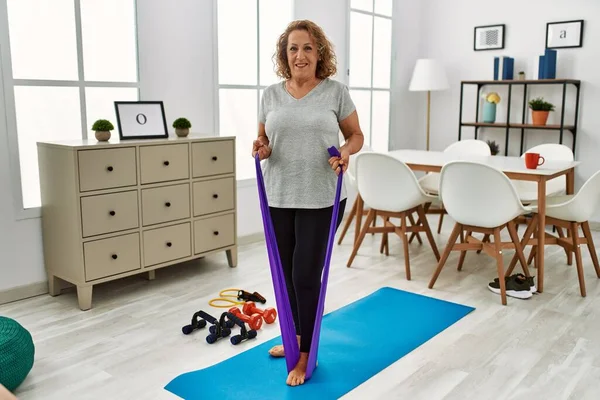 Orta Yaşlı Beyaz Bir Kadın Evde Elastik Bant Kullanarak Kendine — Stok fotoğraf