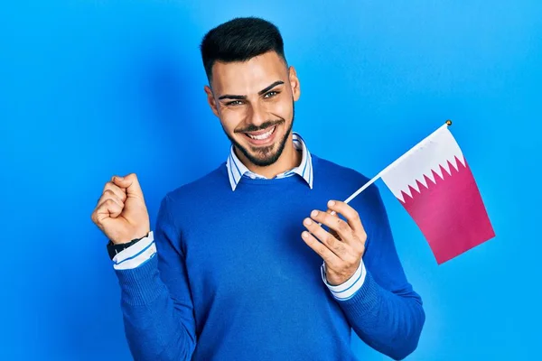 Jovem Hispânico Com Barba Segurando Bandeira Qatar Gritando Orgulhoso Celebrando — Fotografia de Stock