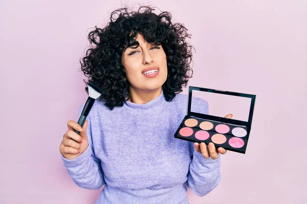 Young Middle East Woman Holding Makeup Brush Blush Clueless Confused — Stock Photo, Image