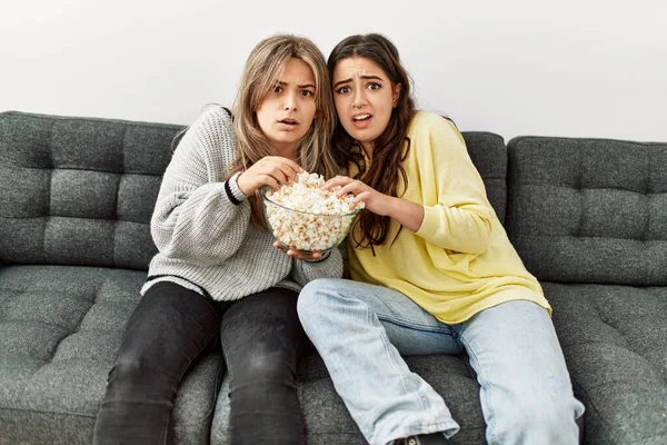 年轻夫妇害怕在家里看恐怖片吃爆米花 — 图库照片